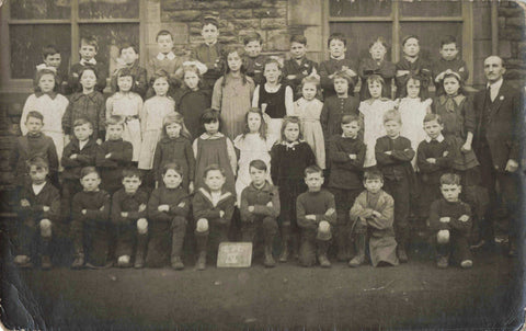 Old real photo postcard of schoolchildren possibly at Atherstone, Warwickshire