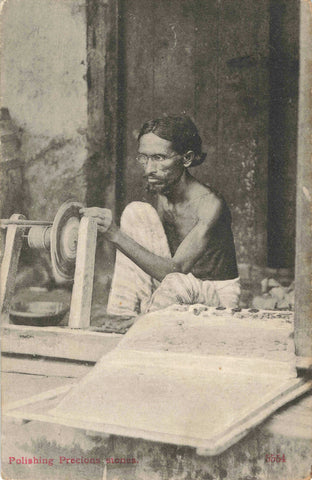 Old postcard of man polishing precious stones
