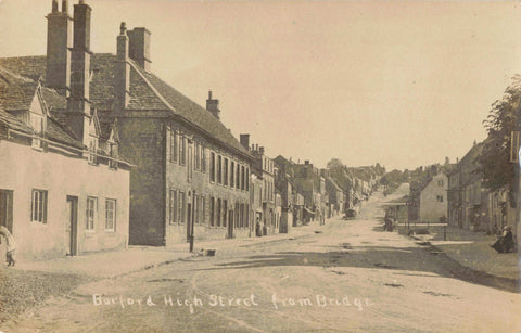 Old real photo postcard of "Burford High Street, from Bridge" in Oxfordshire