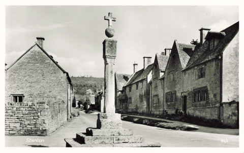 Old real photo postcard of Stanton, Gloucestershire showing the cross