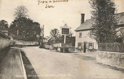 Old real photo postcard of Main Street, Netheravon in Wiltshire