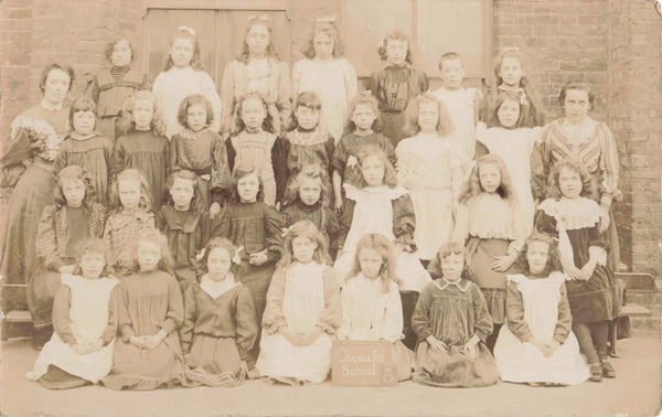 Old real photo postcard of pupils at Odessa Road School, Willesden in London