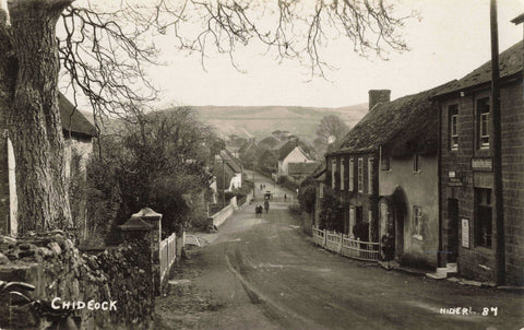Old real photo postcard of Chideock in Dorset, showing post office right foreground