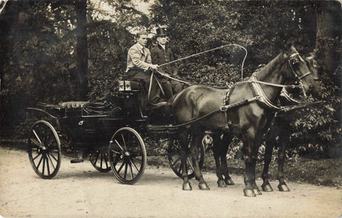 Old real photo postcard of two men in horse drawn carriage, one with a top hat on