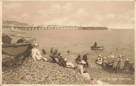 1920s postcard of The Beach and Pier, Hastings - people on beach