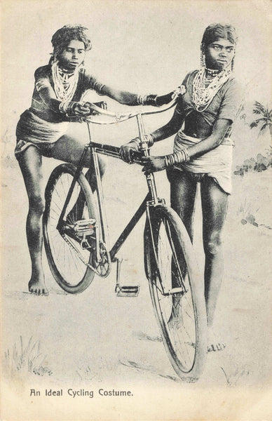 Vintage postcard entitled An Ideal Cycling Costume, showing Indian ladies with a bicycle