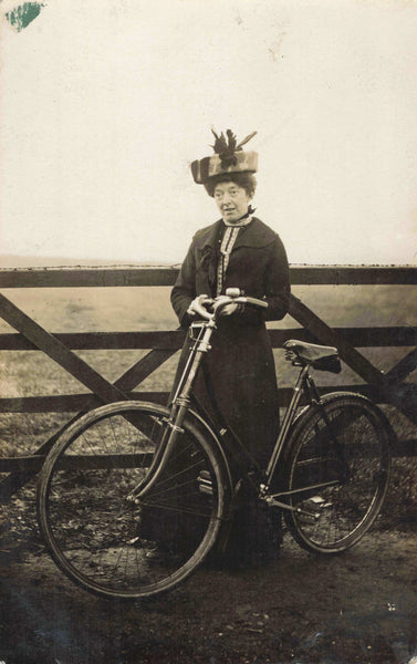Old real photo postcard, lady in hat with a bicycle 