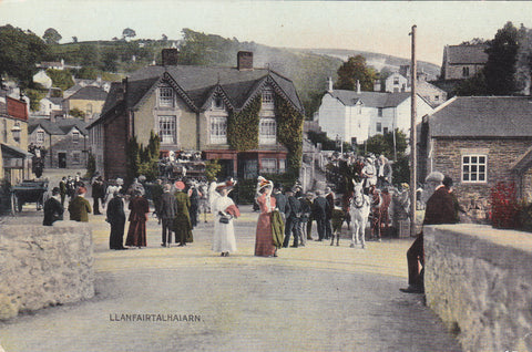Old postcard showing people in the street at Llanfairtalhaiarn in Denbighshire