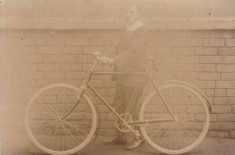 Real photo postcard of unknown young man with bicycle